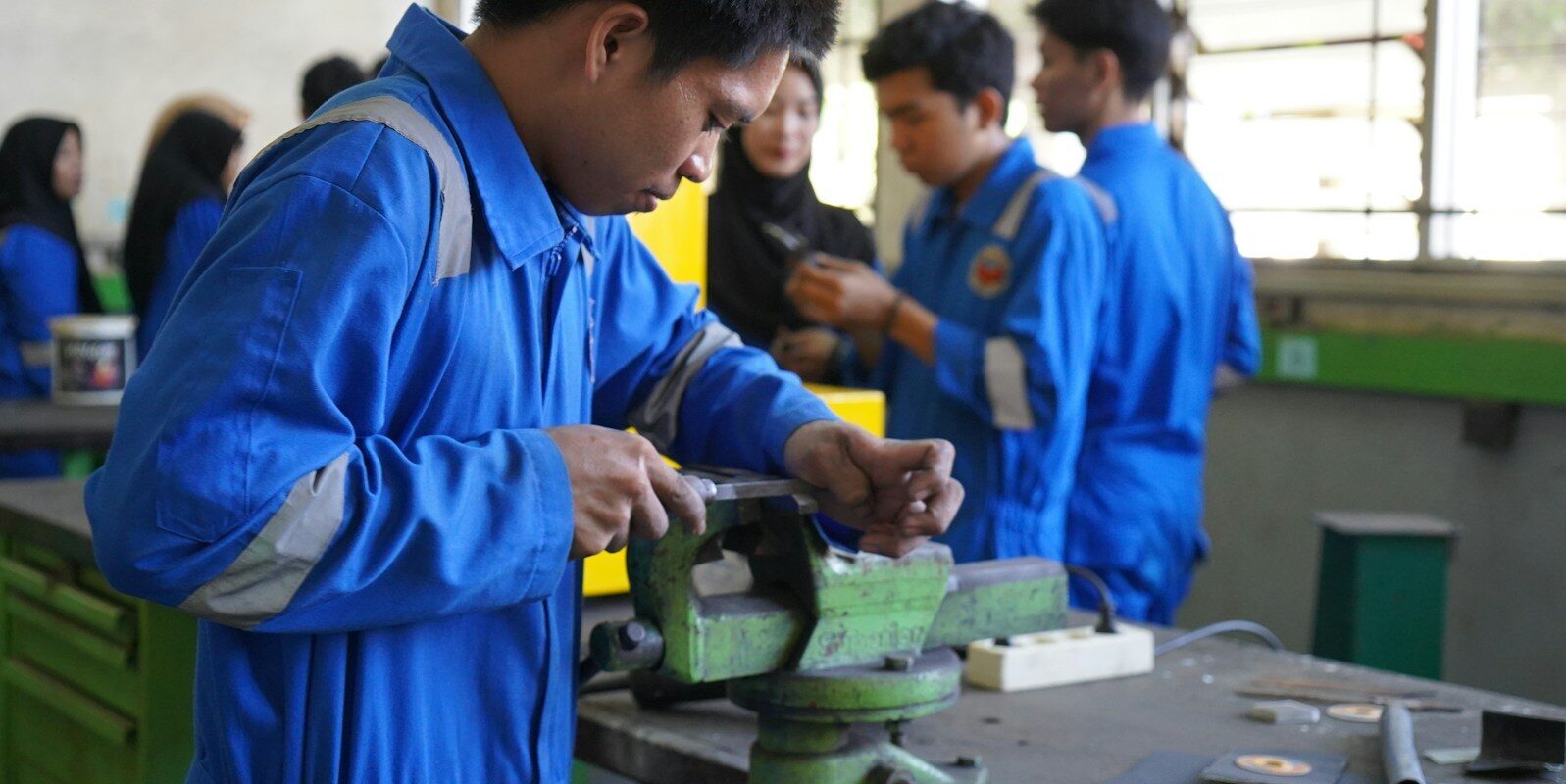 a man working on a machine in a factory