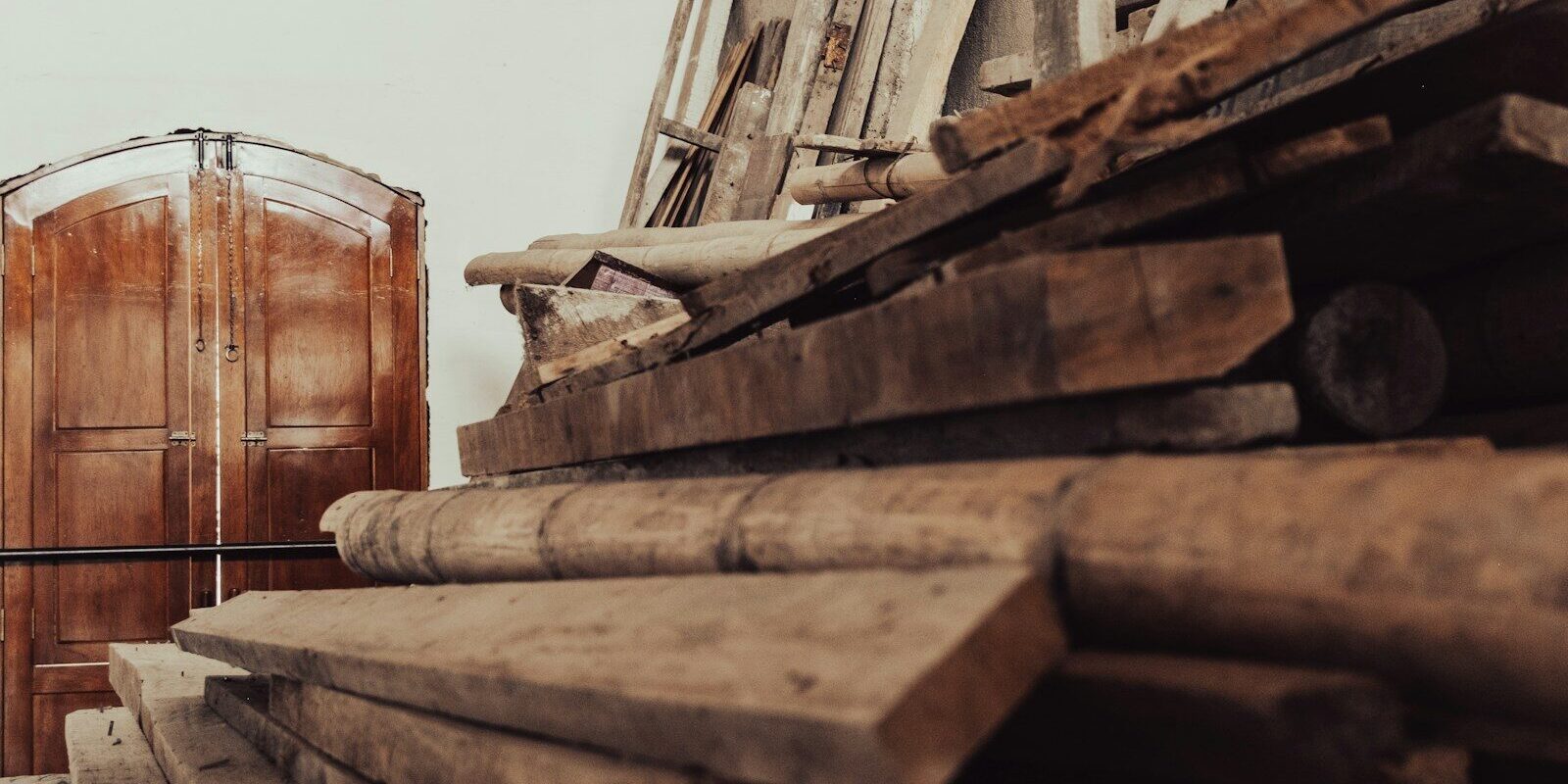 Photo by Jaime Maldonado a large pile of wood in a warehouse
