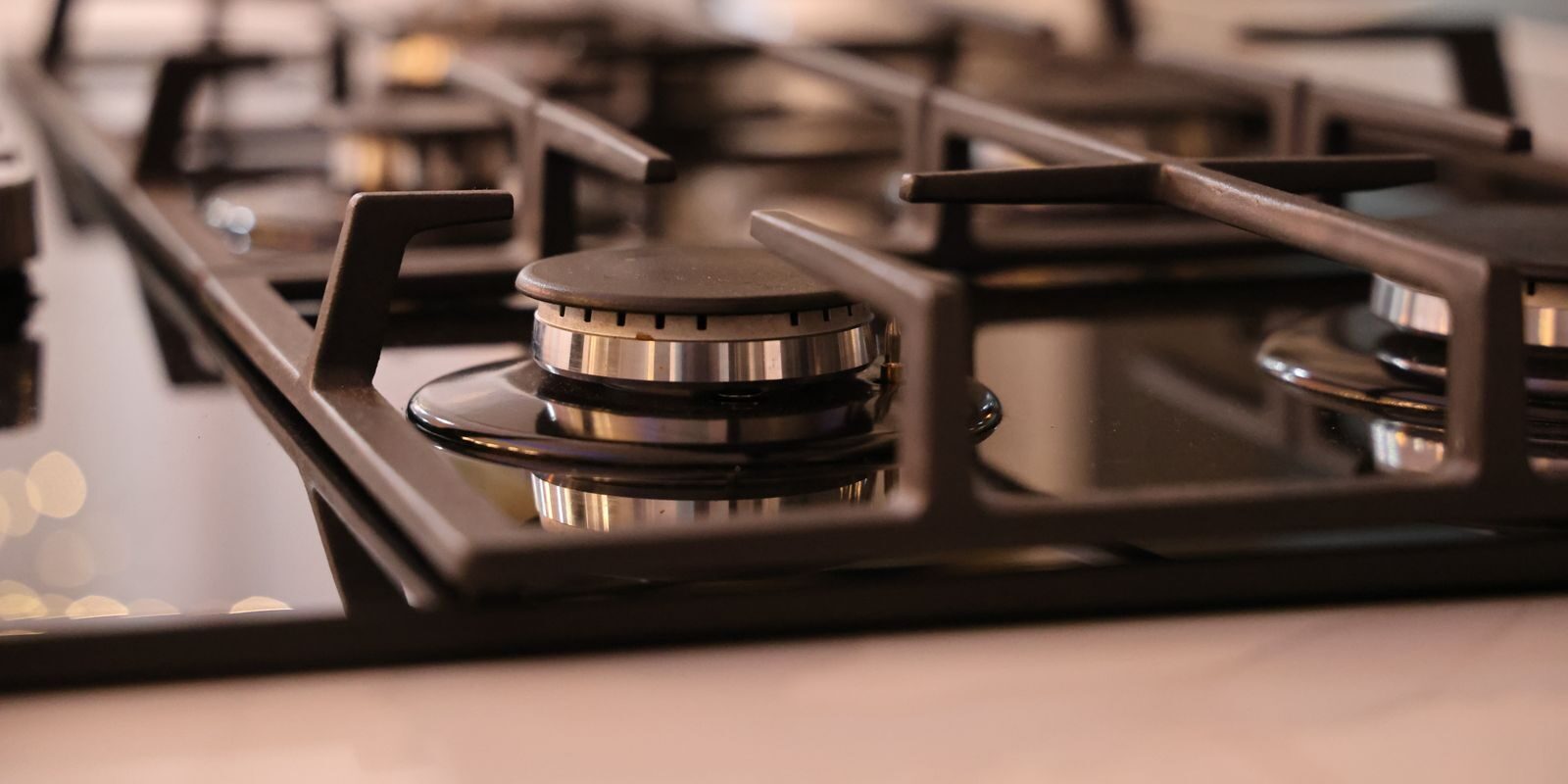 Close-up of a modern stainless steel gas stove top, ideal for contemporary kitchens and cooking environments.