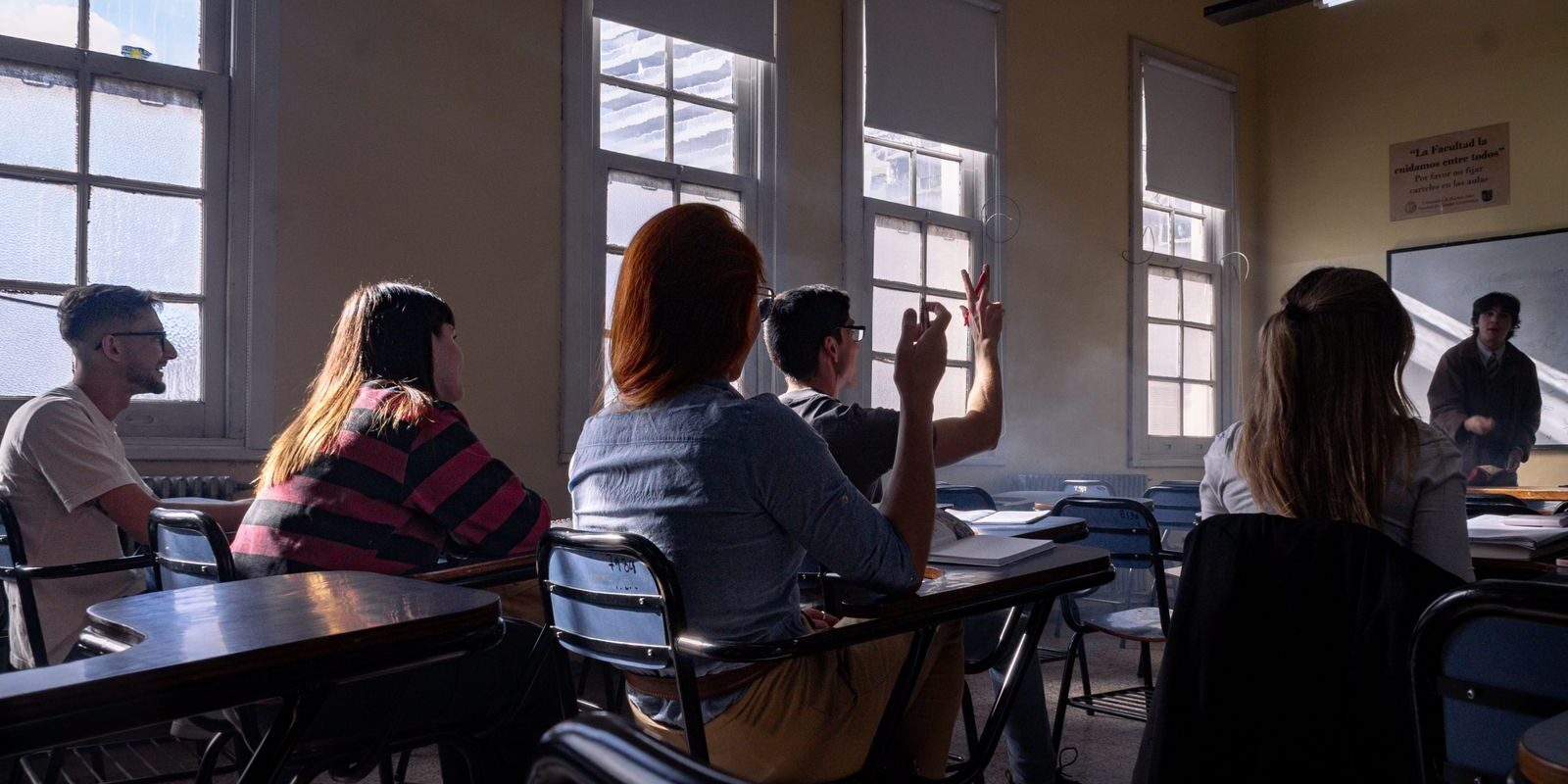 Students attentively listening and participating in a classroom discussion.