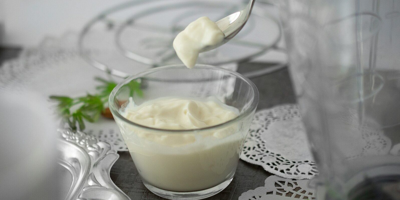 close-up photo of white cream in clear shot glass