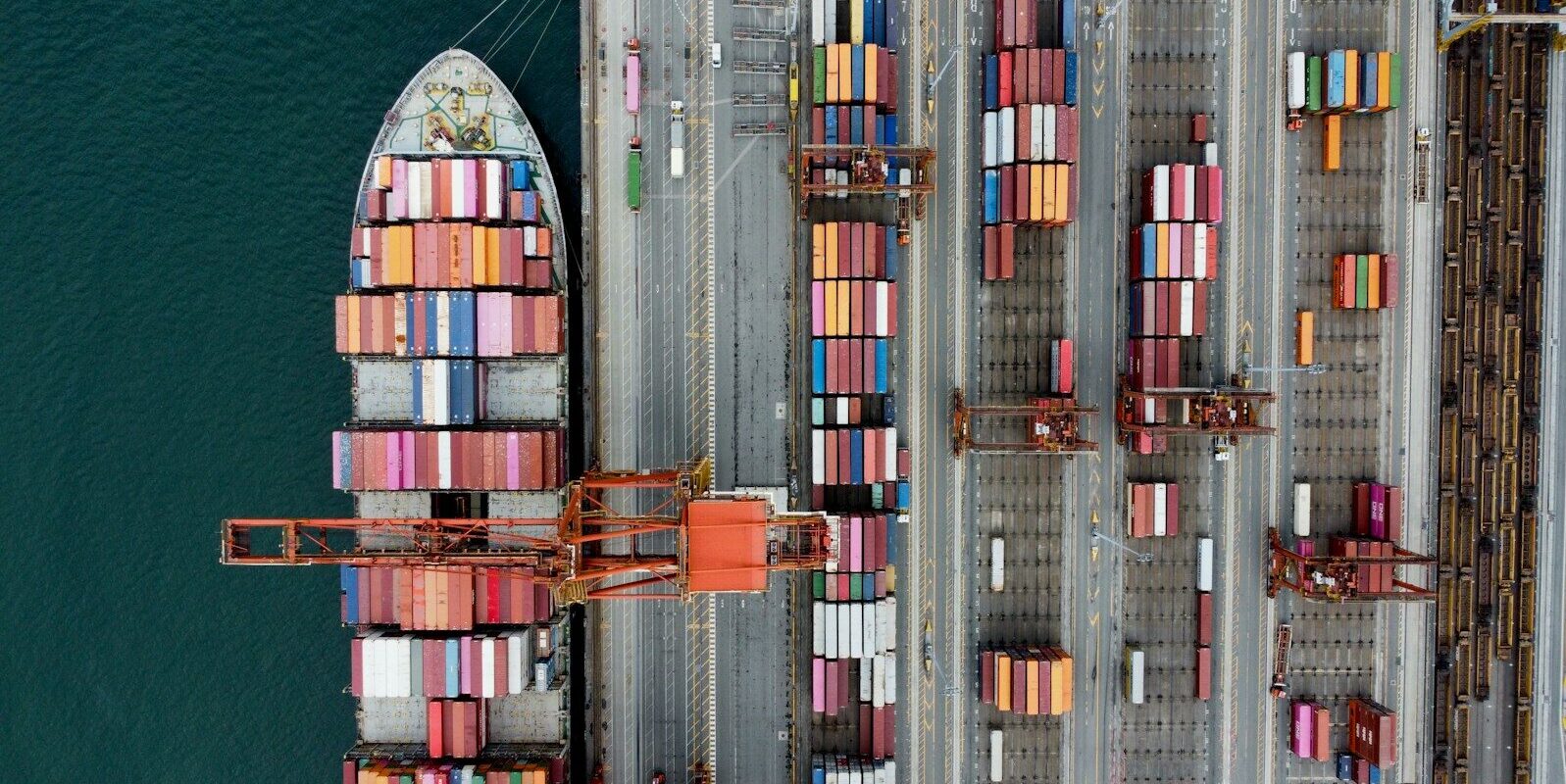 Cargo ship loaded with colorful containers at a busy port