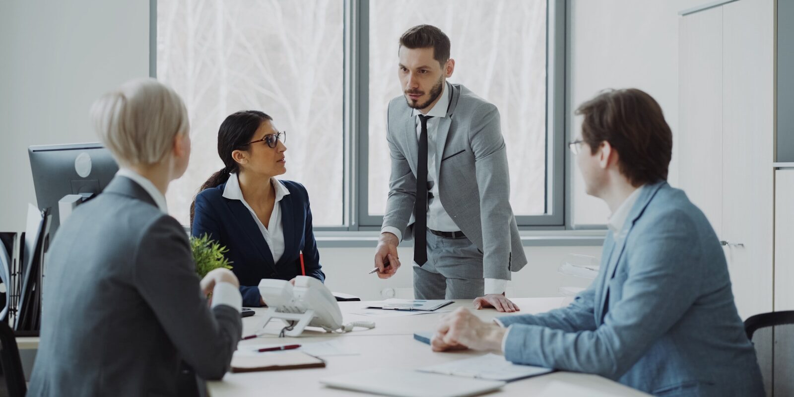 Photo by Vitaly Gariev Business professionals in a meeting around a table