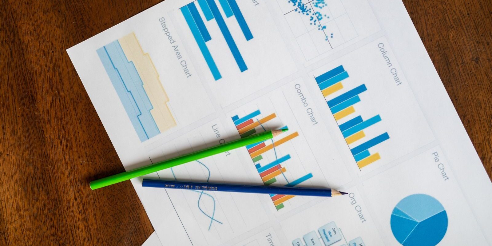 Photo by RDNE Stock project Top view of vibrant charts and colored pencils on wooden surface.