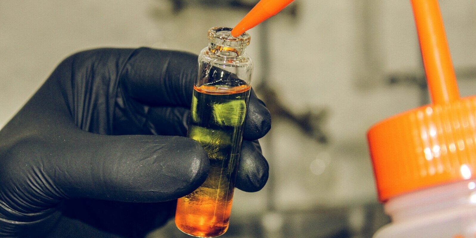 clear glass bottle with orange handle