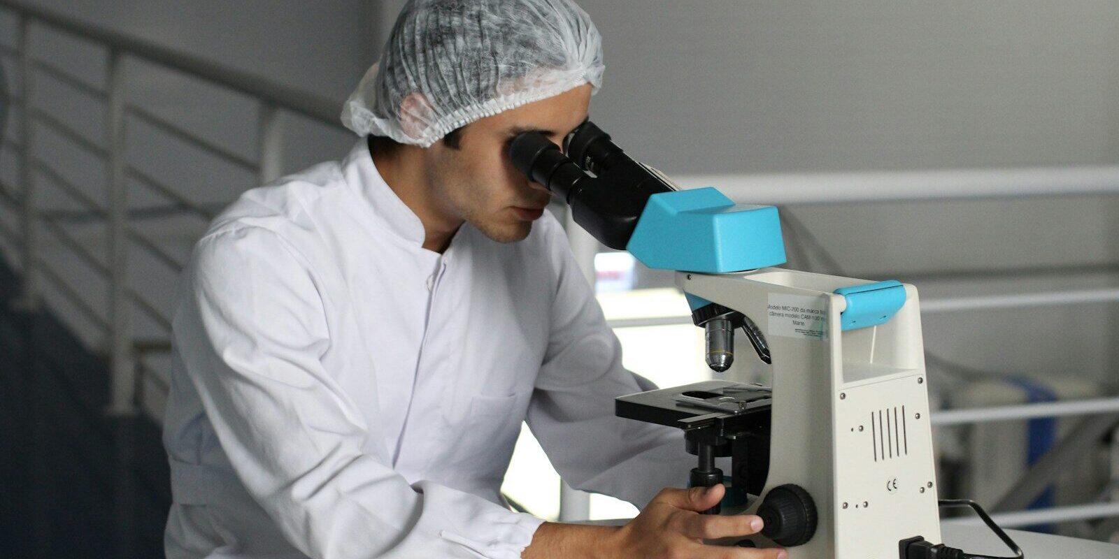 man sight on white microscope