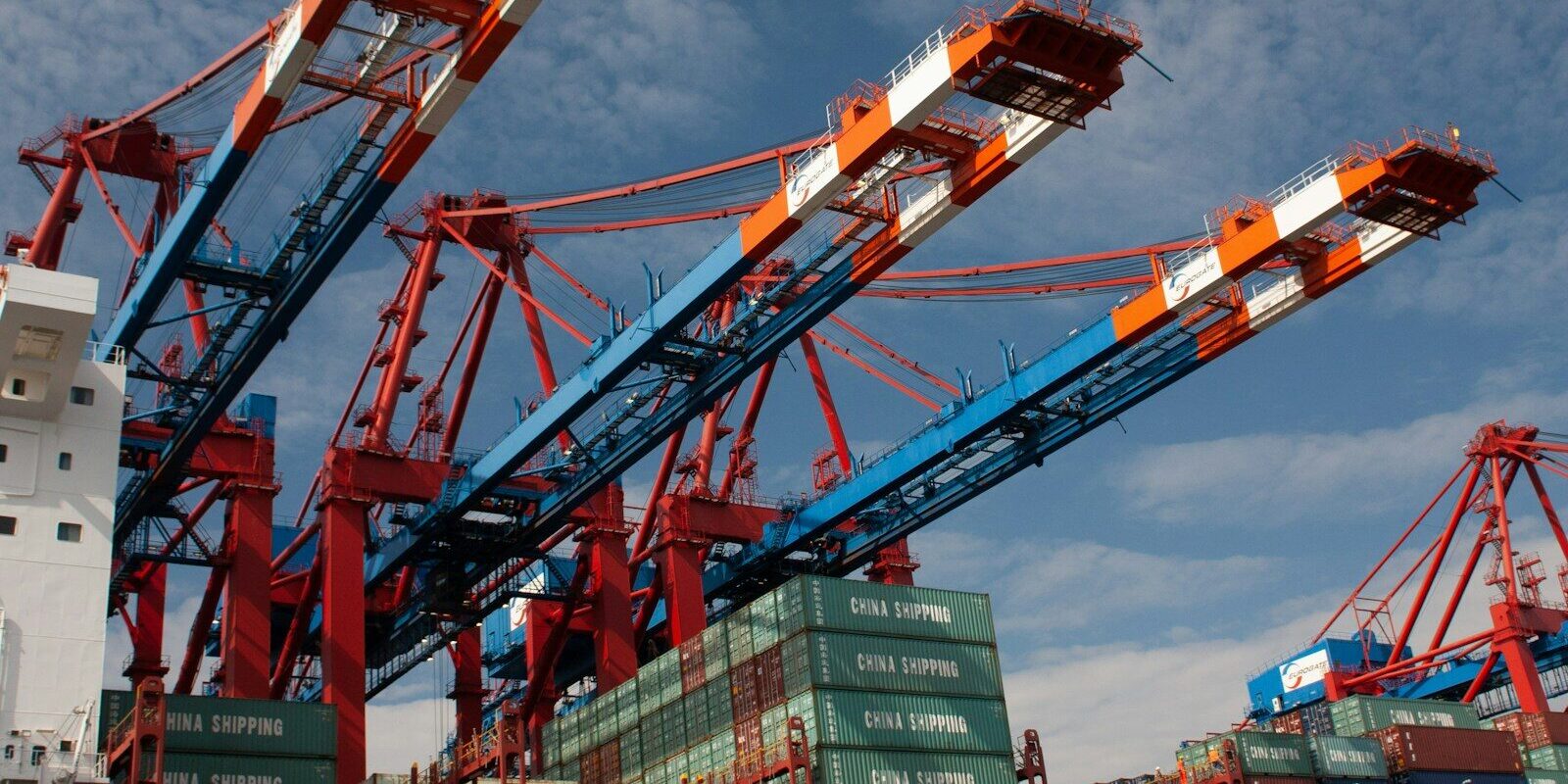 red and blue crane under blue sky during daytime