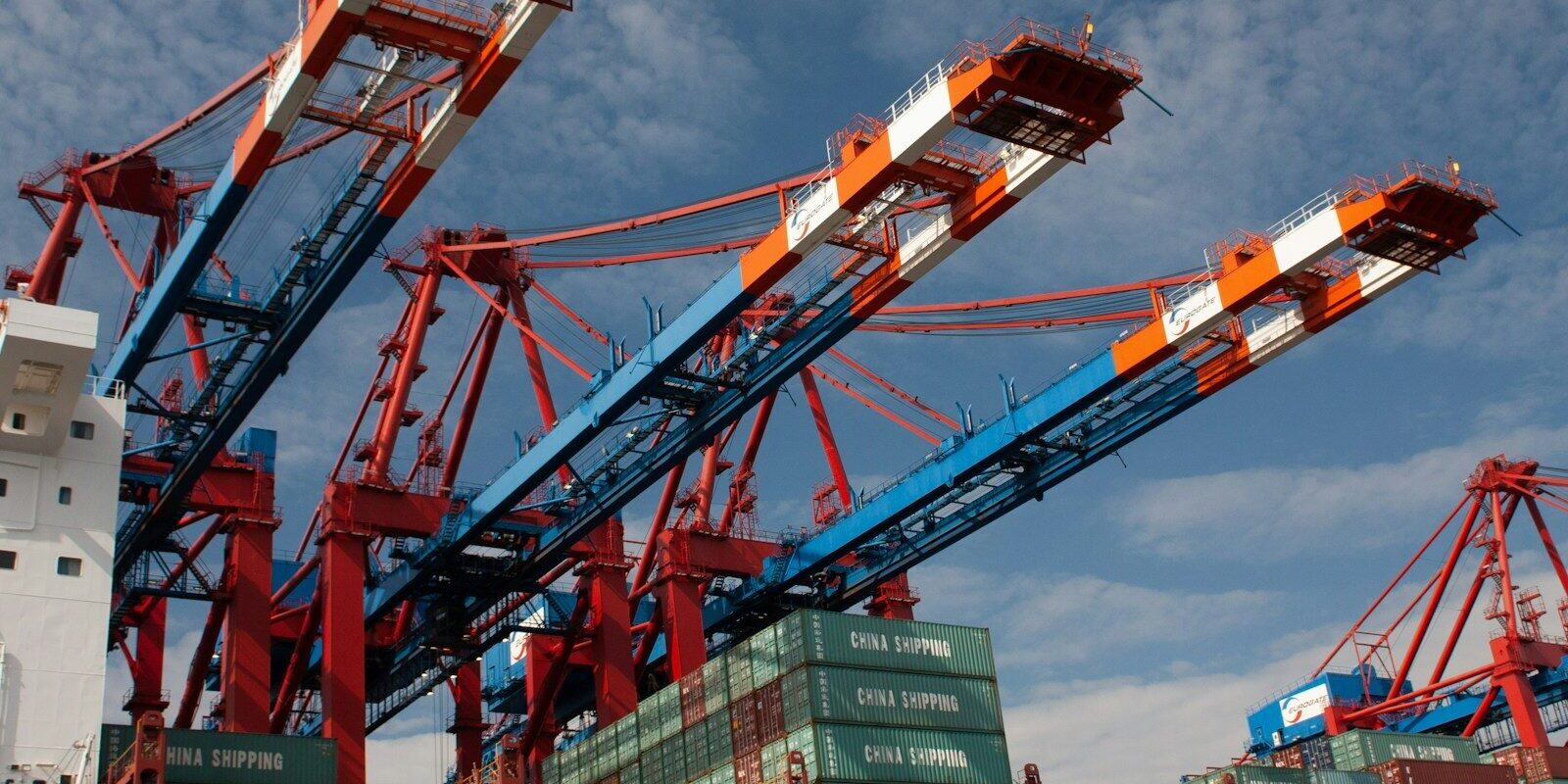 red and blue crane under blue sky during daytime