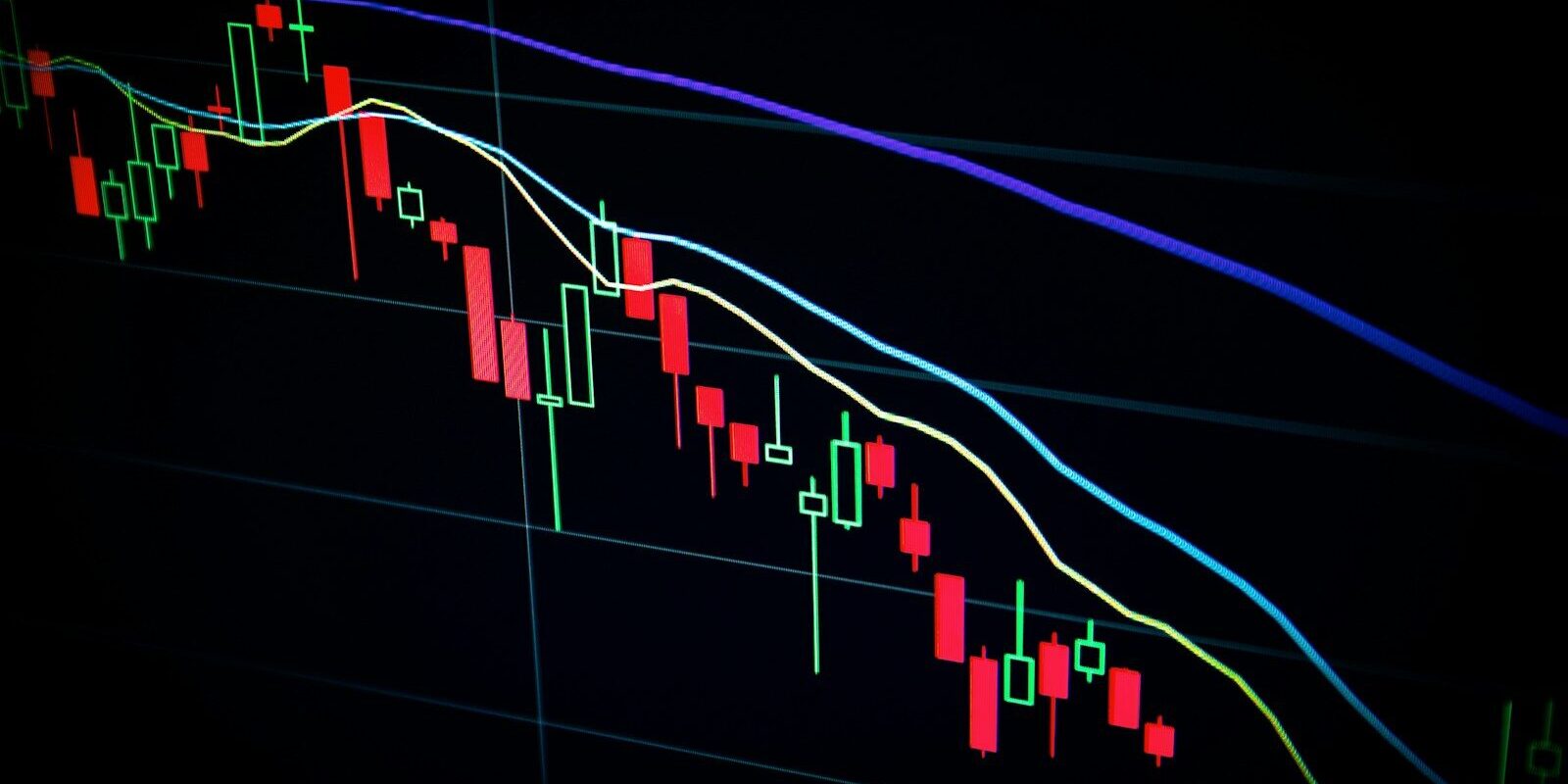 stock market candlestick chart on dark screen