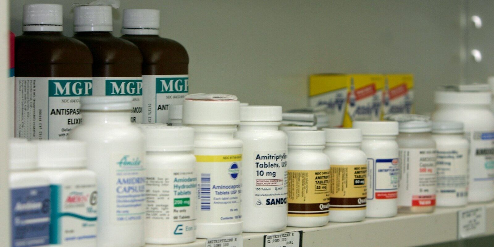 a shelf filled with lots of different types of medicine