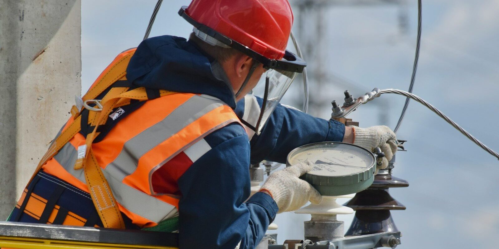 man in blue orange and white jacket wearing red helmet