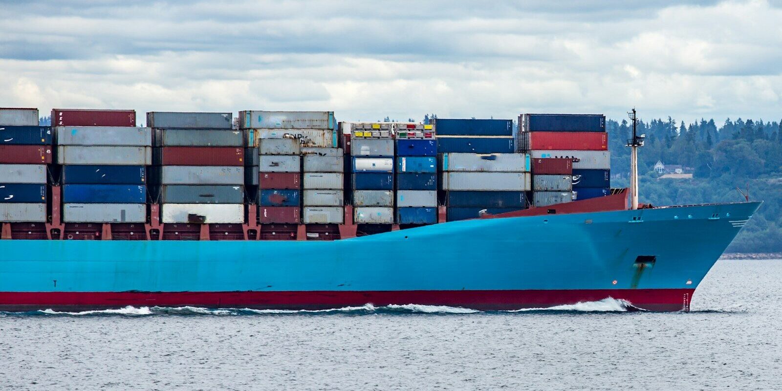 red and blue cargo ship on sea during daytime