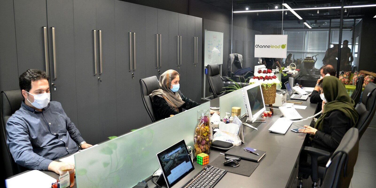 man in black jacket sitting on black office rolling chair