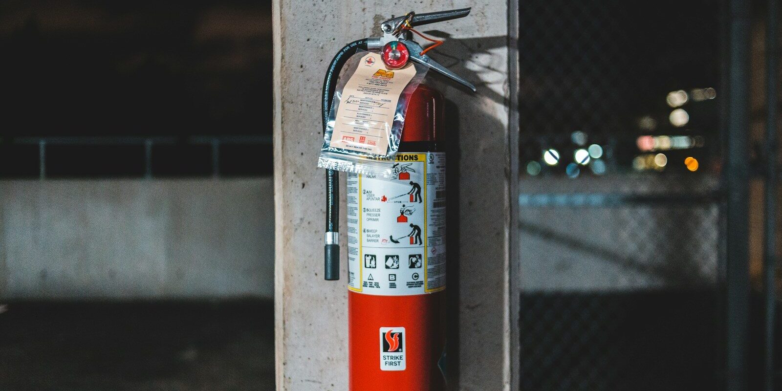 red fire extinguisher mounted on wall
