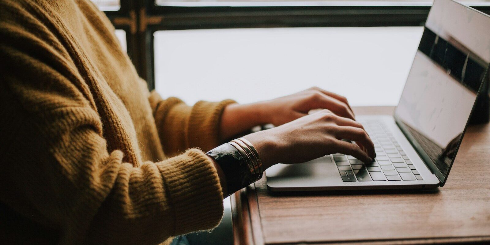 person sitting front of laptop