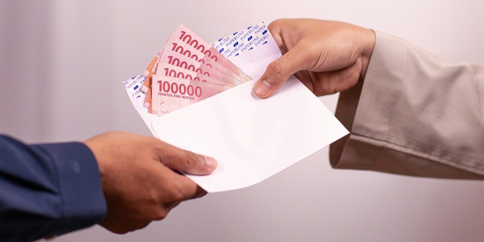 Photo by Defrino Maasy Money is being handed over between two people