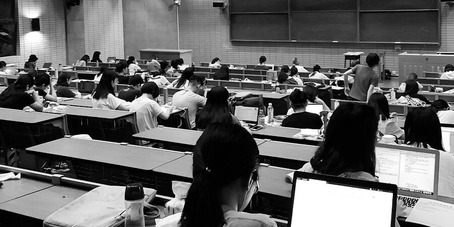 graysacale photo of students in room