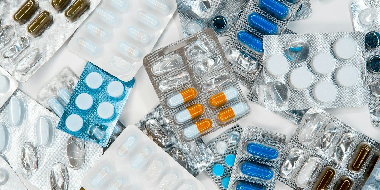 a pile of pills sitting next to each other on top of a table