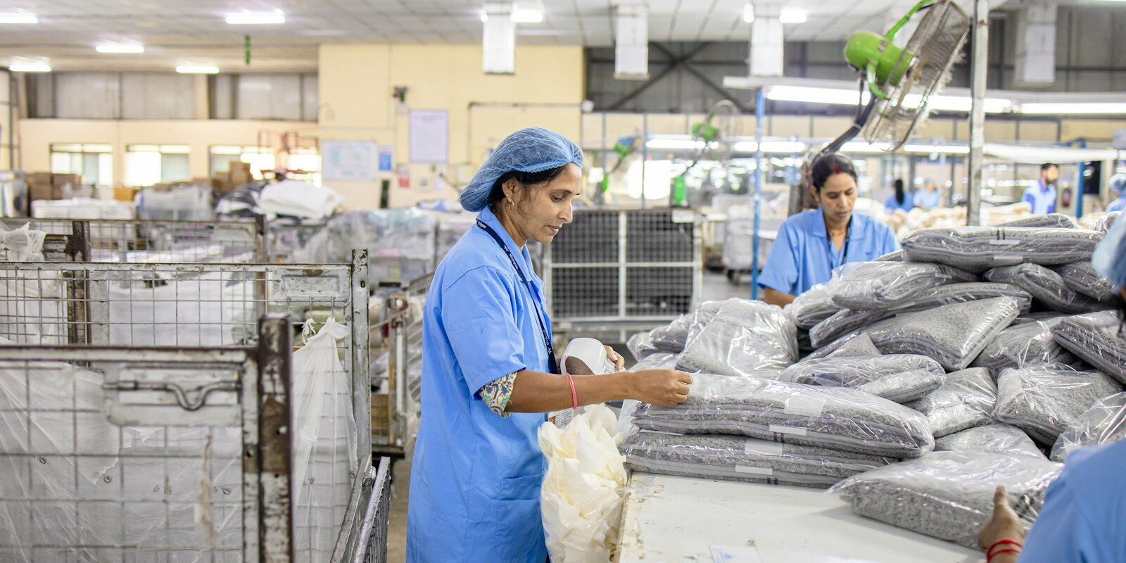 Workers sort and package items in a factory
